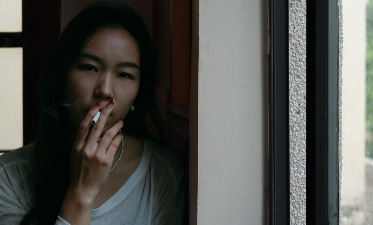 Woman beside a window, photographed by Paul Graf